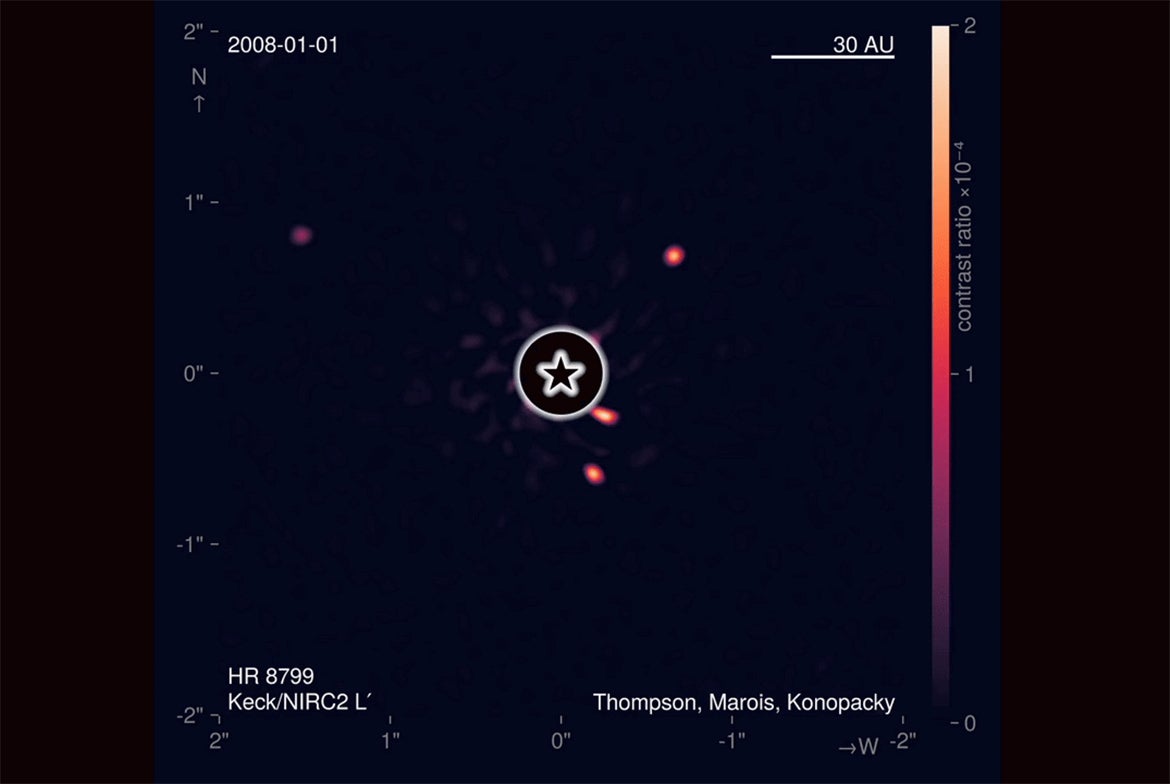 Still image from animation showing four giant planets orbiting a star
